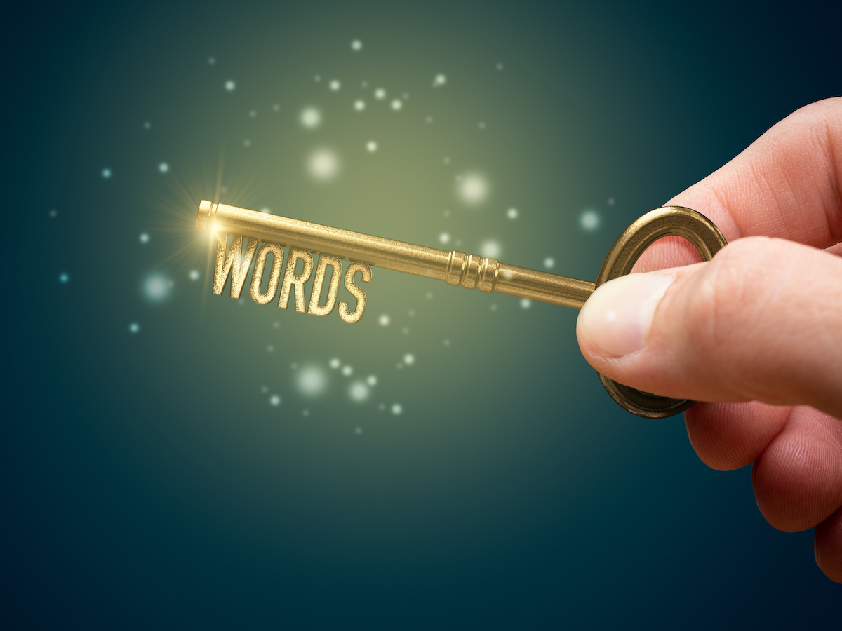 leverage Keywords are a key for successful SEO concept. Unlock potential of your web with optimized keywords. Hand with key with text keywords.